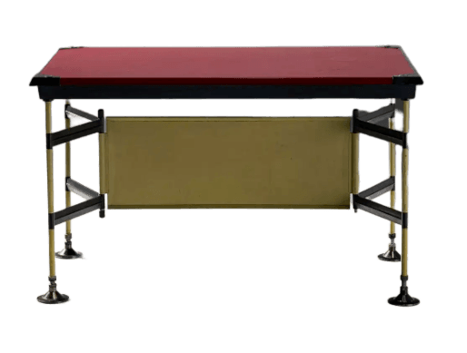 A modern desk with a rectangular red top and a gold-colored panel in the middle section of the frame. The frame is constructed from metal tubing and supports, with a mix of brass-colored and black elements. The legs are slender and feature adjustable feet with a decorative base. — 3D model
