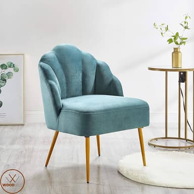 A modern accent chair featuring a distinctive scalloped or shell-like backrest, upholstered in a soft teal fabric, supported by four slender, tapered legs with a metallic finish. — 3D model