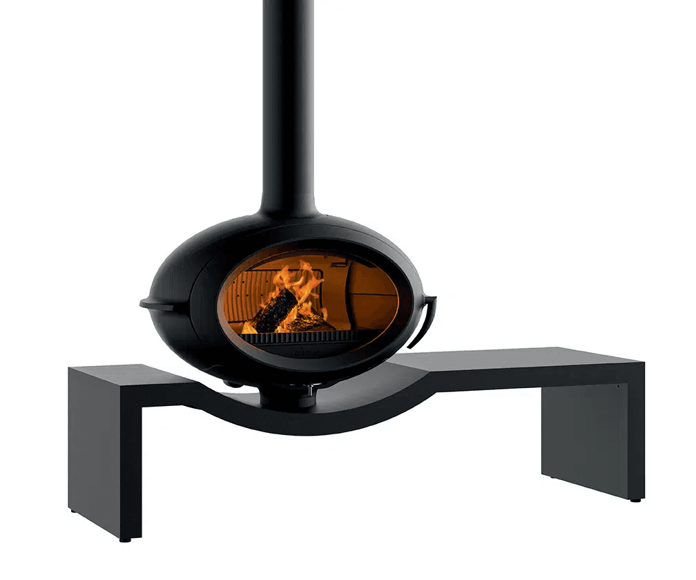 A modern, suspended fireplace with a rounded, oval-shaped combustion chamber featuring a glass viewing panel. It is connected to a vertical flue. The fireplace is supported by a minimalist, black bench-like structure that curves around its base. The combustion chamber contains burning logs. The overall aesthetic is contemporary and sculptural. — 3D model