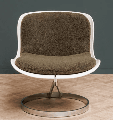 A modern armchair featuring a white molded shell seat and back, with a thick, textured green cushion. The chair is supported by a chrome-plated metal base with a circular pedestal and a curved upright structure connecting to the seat. — 3D model