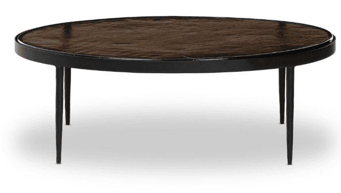 An oval coffee table with a dark, textured top and a thin black frame. It is supported by four slender, tapered black legs. — 3D model