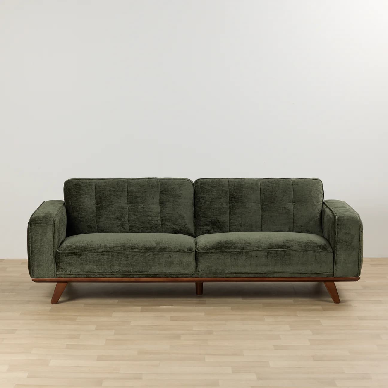 A two-seater sofa with green fabric upholstery, featuring tufted back cushions, square track arms, and an exposed wooden base with tapered wooden legs. — 3D model