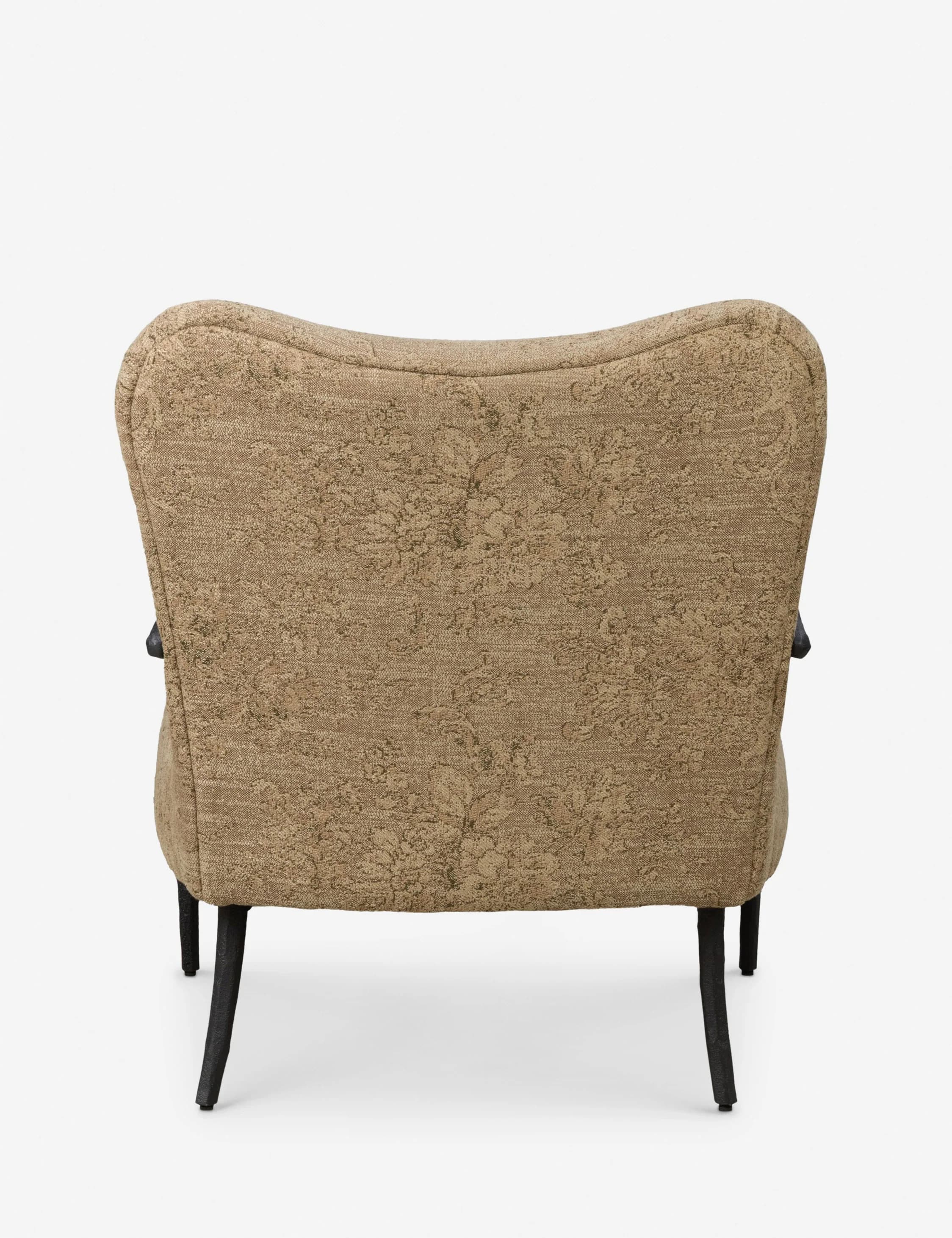 An upholstered accent armchair featuring a high, slightly curved backrest. The chair is covered in a textured fabric with a subtle floral or botanical pattern, in shades of beige, brown, and olive green. It has dark, tapered legs that splay slightly outwards. The armrests are partially visible from the side and appear integrated into the upholstered body. The design suggests a blend of classic comfort with mid-century modern leg styling. — 3D model