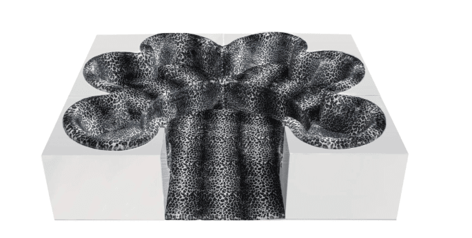 A modular lounge seating system composed of stark white geometric blocks with integrated, organically shaped seating depressions upholstered in a bold black and white leopard print fabric. — 3D model