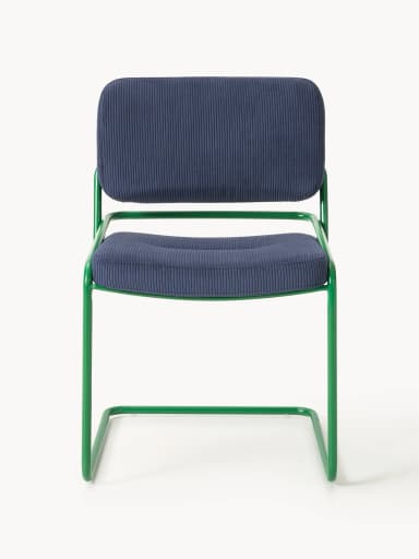 A side profile view of a modern accent chair. The chair features a tubular metal frame, painted in a vibrant green, forming cantilevered legs and armrests. The seat and backrest are upholstered in a navy blue corduroy fabric with a ribbed texture. The seat is slightly tufted. — 3D model