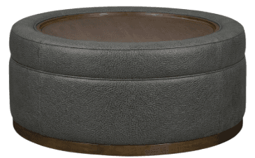 A circular ottoman with a tufted upholstered base and a wooden tabletop. The base is upholstered in a dark gray textured material, possibly faux leather or a durable fabric, with visible stitching. The top features a circular wooden insert with a visible grain pattern, possibly protected by a glass or acrylic overlay. The ottoman is elevated by a thin, circular metal base with a brushed brass or antique bronze finish. — 3D model