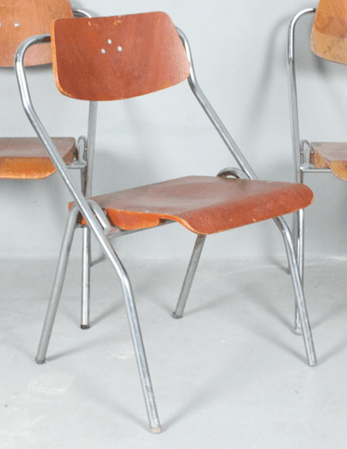 A side chair featuring a bent plywood seat and backrest, supported by a tubular metal frame. The design is simple, functional, and armless, with a natural wood grain finish and a silver-toned metal frame. — 3D model