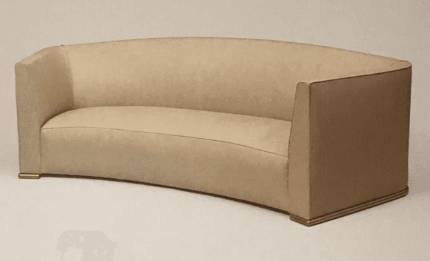 A curved, armless sofa with a tailored upholstery. The sofa features a subtle arc in its backrest and seat, with straight, rectangular arms that transition into the curved back. The base is defined by a low plinth with a thin, decorative trim at the top and bottom. — 3D model