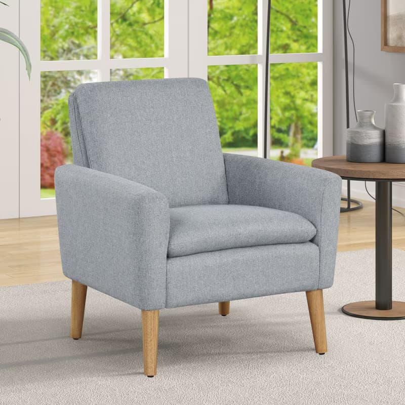 A light gray upholstered armchair featuring a clean, contemporary design with a single seat cushion, padded armrests, and four outward-splayed, tapered wooden legs. — 3D model