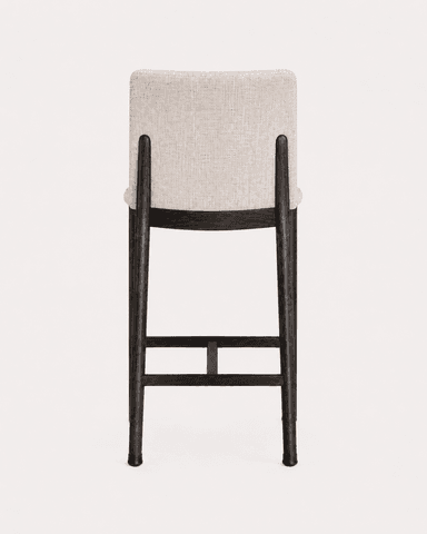 A contemporary bar stool featuring an upholstered seat and backrest set on a dark wooden frame with integrated footrests. — 3D model