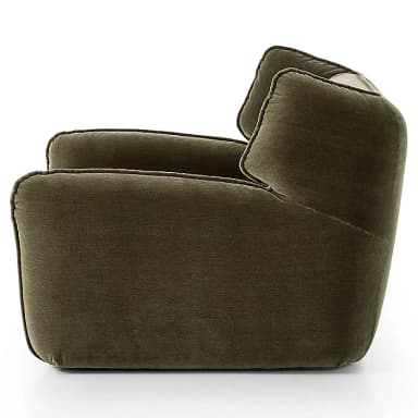 A plush, olive green velvet upholstered lounge chair featuring rounded, integrated armrests and a high back with soft, wing-like side panels. The chair's design emphasizes comfort with its deep seating and soft, inviting contours, highlighted by subtle piping along the seams. — 3D model