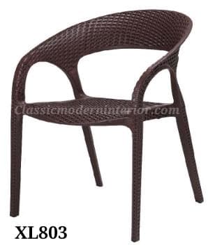 A dark brown, molded plastic armchair designed with a textured surface mimicking woven rattan. It features a curved backrest and integrated armrests, with cut-outs beneath the arms. The seat and back have a perforated, lattice-like pattern. It stands on four tapered legs, each also textured. — 3D model