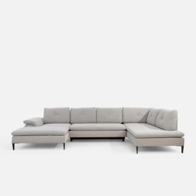A U-shaped sectional sofa with light grey fabric upholstery. The sofa features tufted back cushions and a chaise lounge on one end and a rounded armrest on the other. It is supported by dark, tapered legs. — 3D model