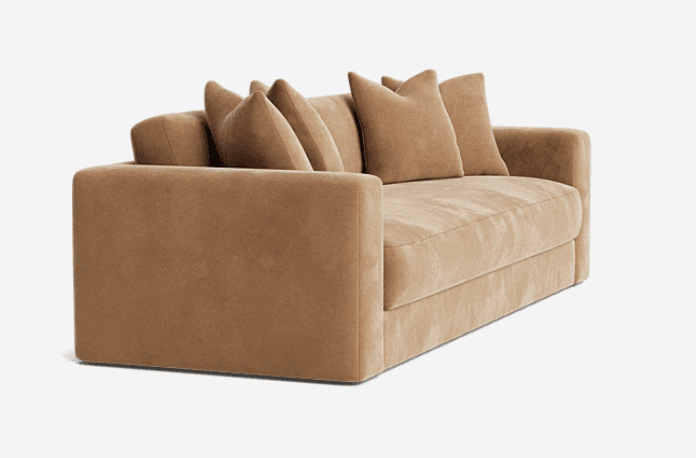 A contemporary tan-colored upholstered sofa featuring a minimalist design, track arms, and plush loose back cushions. — 3D model