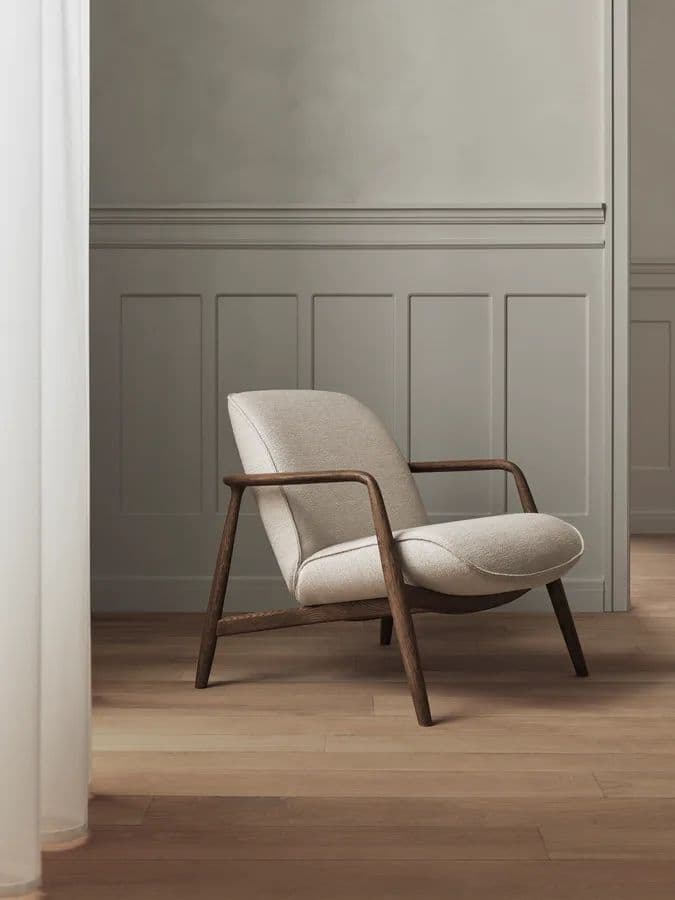 A contemporary lounge chair featuring a curved, off-white upholstered seat and backrest, supported by an exposed dark wood frame that forms the legs and armrests. The chair exhibits a minimalist design with clean lines and a comfortable aesthetic. — 3D model
