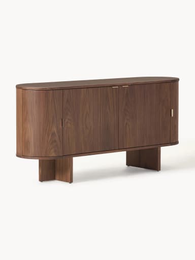 A mid-century modern inspired cabinet with a rounded, cylindrical body and a plinth base. It features two vertically oriented doors with concealed handles and a curved top surface. The material appears to be solid wood with a prominent grain pattern. — 3D model