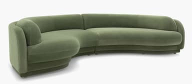 A modular, curved sectional sofa upholstered in a soft, green velvet-like fabric. The sofa features rounded edges and a layered, almost sculptural base. The design is contemporary with organic, flowing lines, suggesting a modern or art deco-inspired aesthetic. It appears to be composed of at least two connected sections to form the corner shape. — 3D model