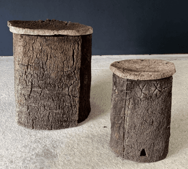 A cylindrical stool with a textured, bark-like exterior and a flat, circular cork top. — 3D model