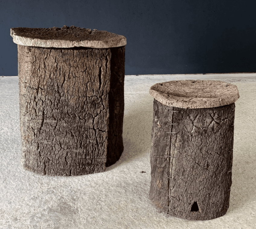 A cylindrical stool with a textured, bark-like exterior and a flat, circular cork top. — 3D model