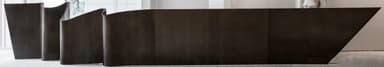 An elongated, low-profile credenza featuring a distinctive undulating or wavy front facade. The piece has a dark, possibly wooden or laminate, finish and appears to be designed for modern interiors, likely as a wall-mounted unit or with a recessed base to give a floating appearance. It contains multiple hidden storage compartments. — 3D model