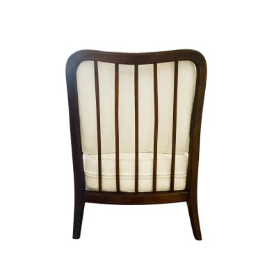 A wooden armchair with a dark stained finish and upholstered seat and back cushions. The armrests have a curved silhouette, and the back features a geometric lattice pattern created by intersecting wooden slats. The legs are slender and tapered. — 3D model