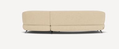 A modern curved sectional sofa, upholstered in a light beige or cream textured fabric, featuring a flowing, organic form and supported by slender, angled dark metal legs. — 3D model