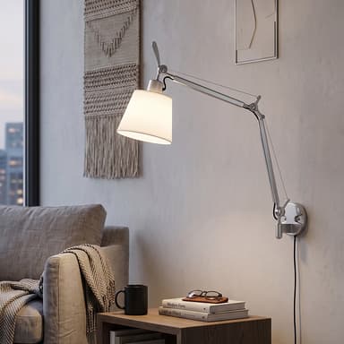 A wall-mounted lamp featuring a brushed silver-grey metal articulated arm with spring-balanced tension cables, and a conical white fabric shade. The lamp has a plug-in cord extending from its wall-mounted base. — 3D model