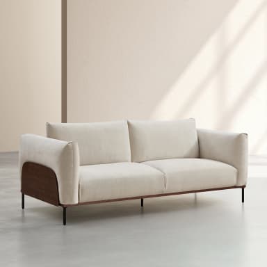 A two-seater sofa featuring a light beige fabric upholstery, dark wood armrest panels, and slender black metal legs. The design is clean and modern, with plush seat and back cushions, suggesting comfort while maintaining a refined aesthetic. The wooden panels add a distinctive visual element to the sofa's profile. — 3D model