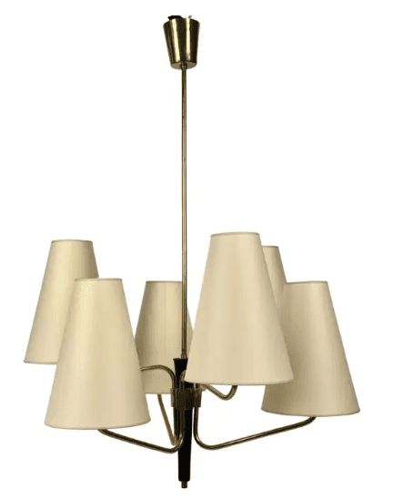 A vintage Mid-Century Modern chandelier featuring a central brass stem descending from a ceiling canopy. Six radiating arms, also in brass, extend outwards, each terminating in an upward-pointing, conical, off-white fabric shade. The central column has a prominent black accent piece, providing a striking contrast to the brass finish. The design is characteristic of the 1950s to 1960s, emphasizing clean lines and functional elegance. — 3D model