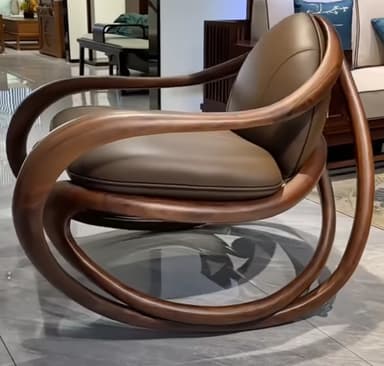 A modern lounge chair featuring a sculptural bentwood frame in a dark wood finish, with integrated armrests and a curved base. The chair is fitted with smooth, upholstered cushions in a tan or light brown leather or faux leather for both the seat and backrest, emphasizing fluid lines and comfort. — 3D model