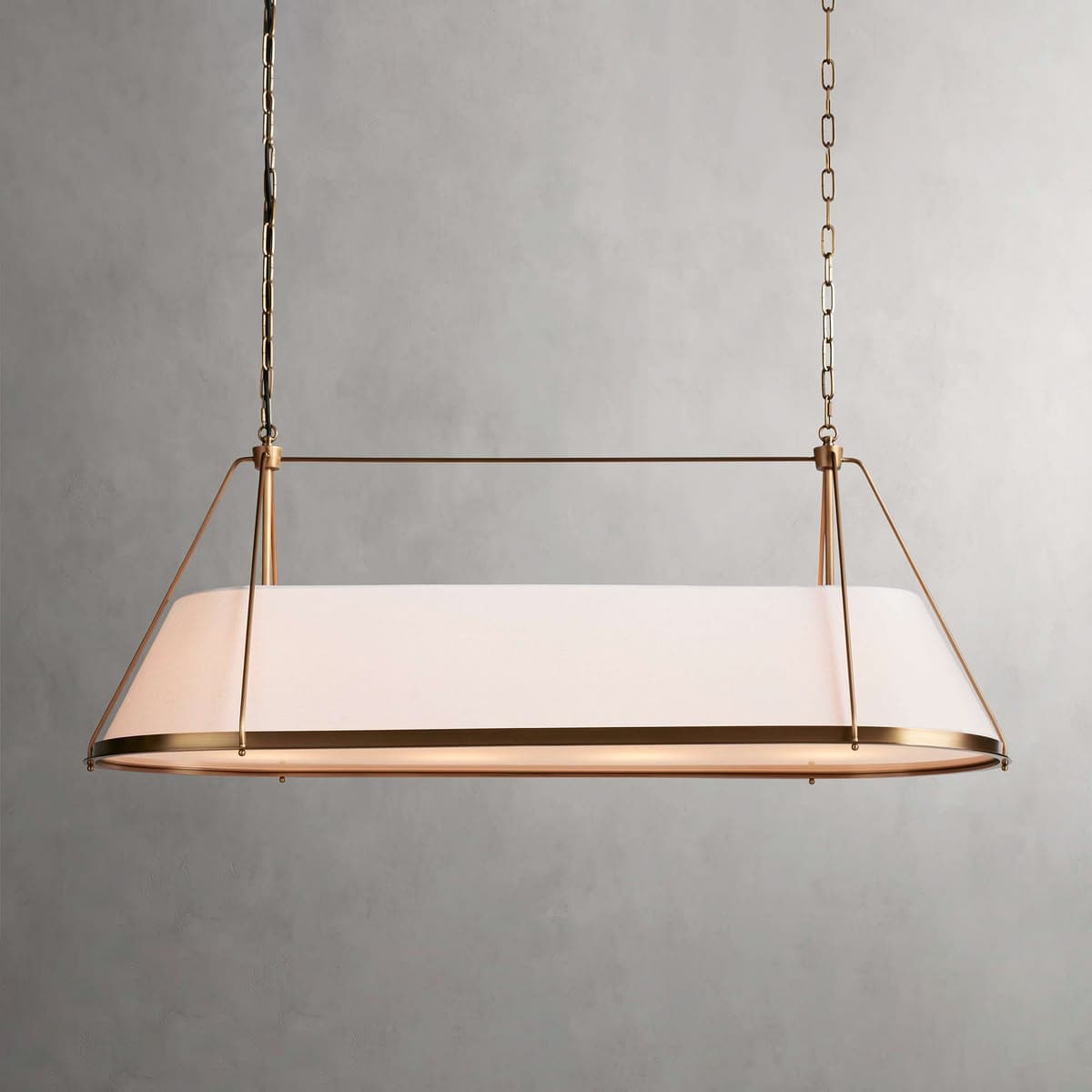 A contemporary linear pendant light featuring a rectangular frosted glass diffuser suspended by a brass-finished metal frame and chains. The light provides diffused illumination. — 3D model