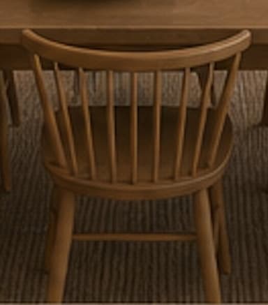 A light natural wood chair with a spindle back and a gently curved top rail, featuring a contoured saddle seat and splayed round legs joined by stretchers. — 3D model