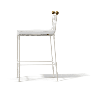 A white bar stool featuring a backrest constructed from wide interwoven straps, a cushioned seat, and decorative brass finials on the back posts. The frame is slender and includes an integrated footrest. — 3D model