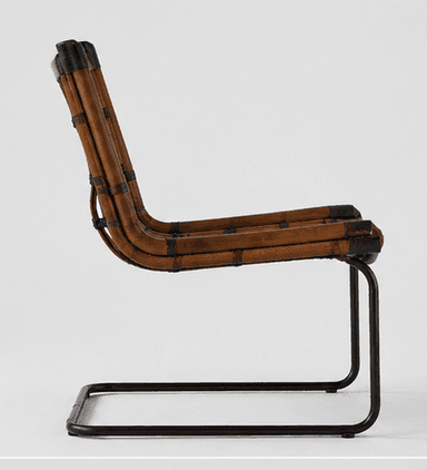 An armless lounge chair featuring a natural rattan or cane seat and backrest with a tubular black metal sled base. The woven material is a warm brown tone, secured to a bent rattan frame, which is then attached to the minimalist metal frame. The design presents a relaxed and contemporary aesthetic. — 3D model