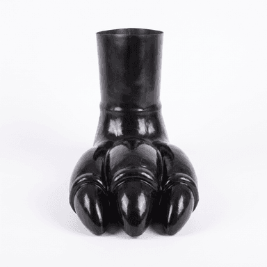 A black, glossy decorative object shaped like a large, stylized animal paw or clawed foot, with a cylindrical opening at the top, typically used as a vase or sculptural accent. — 3D model