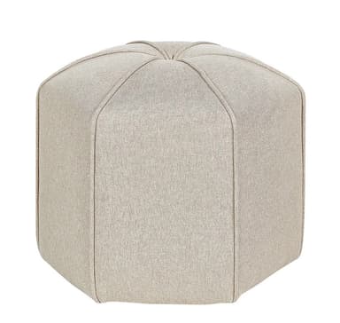 An upholstered hexagonal ottoman featuring a light beige fabric finish. The top surface has radiating seam lines, creating a geometric pattern, which extends down the faceted sides of the piece. It sits directly on the floor with no visible legs, providing a solid, stable form. — 3D model