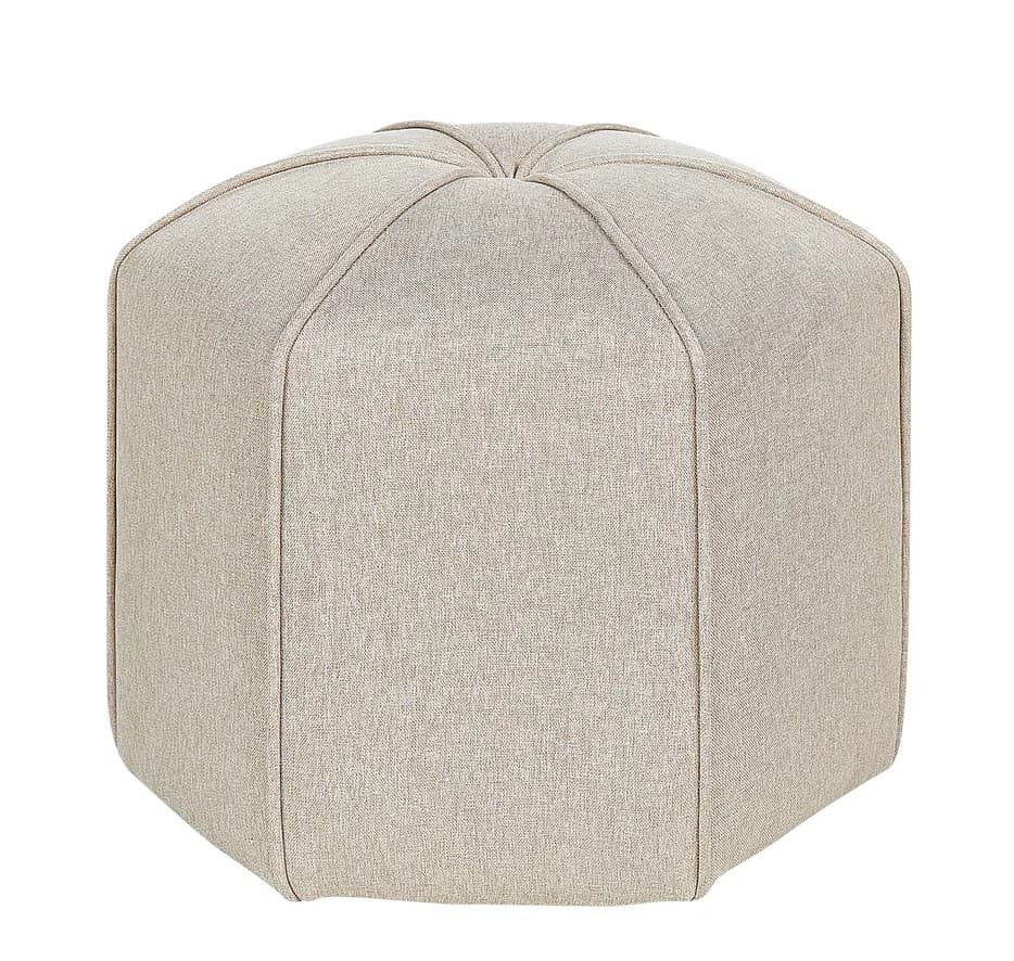 An upholstered hexagonal ottoman featuring a light beige fabric finish. The top surface has radiating seam lines, creating a geometric pattern, which extends down the faceted sides of the piece. It sits directly on the floor with no visible legs, providing a solid, stable form. — 3D model