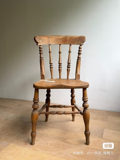 A vintage wooden side chair featuring a spindle back, turned legs, and a saddle-shaped seat, showcasing natural wood grain and signs of age. — 3D model