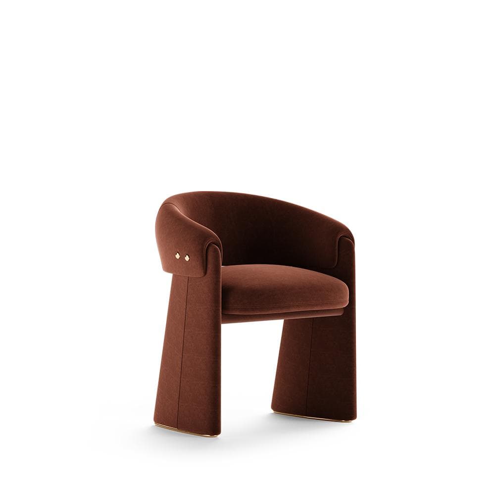 A contemporary upholstered accent armchair featuring a monolithic and sculptural design. It is fully upholstered in a rich, russet-brown velvet, with integrated armrests and substantial block legs. Decorative brass studs adorn the exterior of the armrests, and a thin gold-finished trim accents the base of the legs. — 3D model