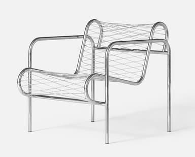 A contemporary armchair featuring a continuous frame constructed from polished tubular chrome. The seat and backrest are composed of a finely woven or welded mesh grid of the same chrome-plated material, creating a transparent and sculptural form. The chair exhibits a minimalist aesthetic with integrated armrests that flow directly from the main frame. — 3D model