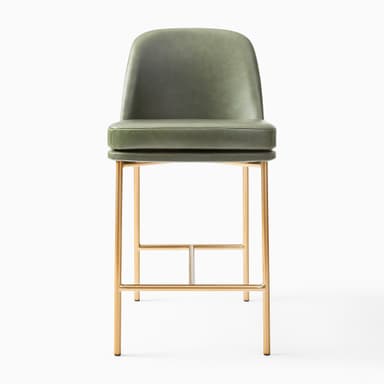 A contemporary bar stool featuring a comfortable green faux leather upholstered seat and backrest, supported by a slim, gold-finished metal frame with an integrated footrest. — 3D model