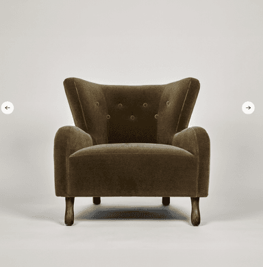 A high-backed upholstered lounge chair in a deep olive green velvet-like fabric, featuring button tufting on the backrest, rounded armrests, and short, splayed dark wood legs. — 3D model