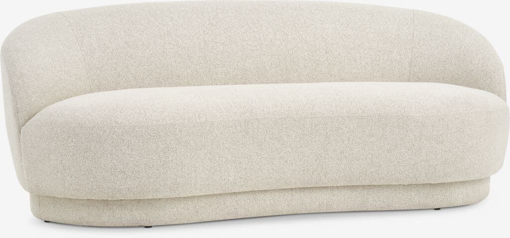 A modern, upholstered sofa with a curved silhouette and a low-profile base. The sofa features soft, textured upholstery and appears to be designed for comfort and contemporary aesthetics. The base has a rounded, continuous form. — 3D model