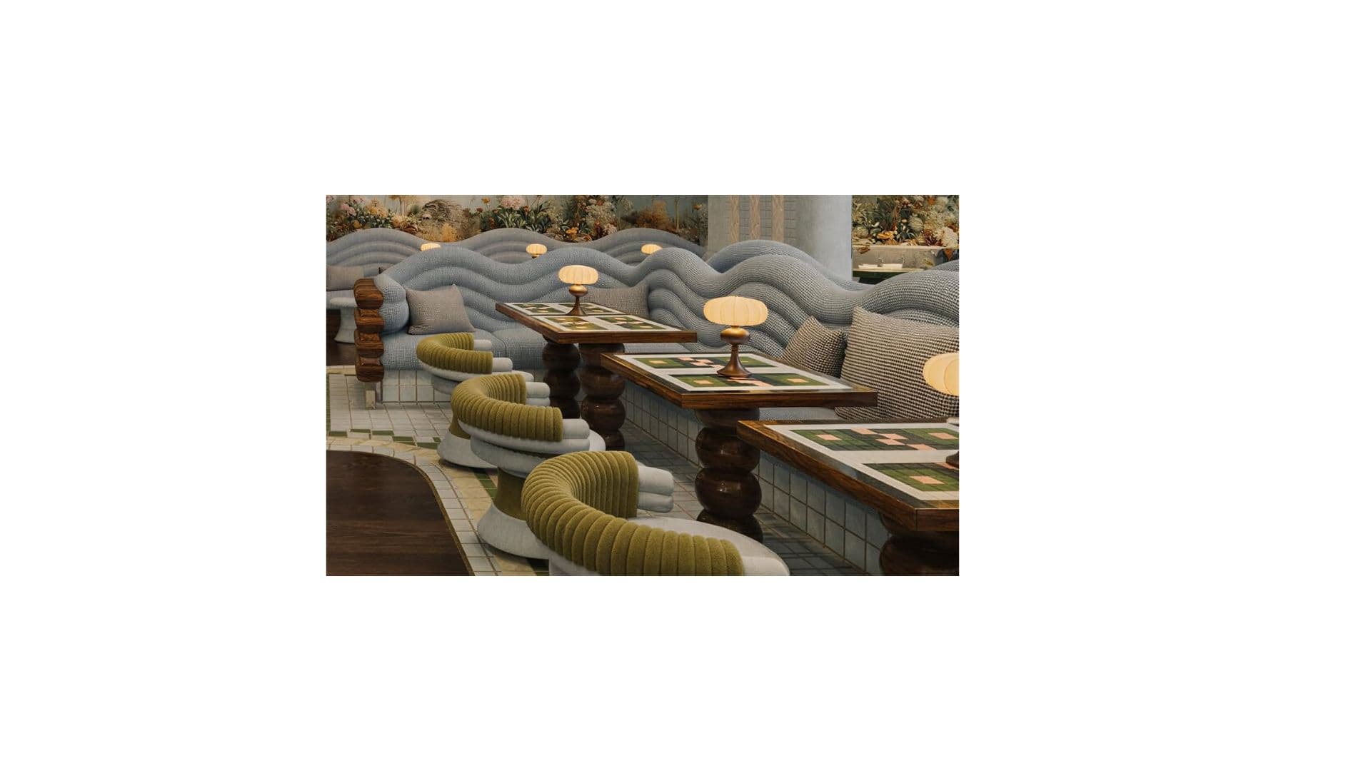 A modular sofa unit with a distinctive organic, wave-like shape. It features a primary seating area upholstered in a textured grey fabric with a ribbed pattern on the backrest and armrests. Two rectangular cushions in a neutral tone are placed on the seating area. The exterior of the sofa, particularly the rounded end, is upholstered in a ribbed olive-green fabric. A small table with a mosaic-patterned top and a wooden base is integrated into the seating arrangement. A small table lamp with a textured shade sits on the table. — 3D model