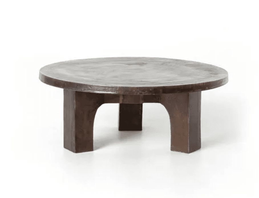 A low, round coffee table featuring a thick, circular top and sturdy, block-like legs, all finished in an aged dark bronze or similar metal, giving it a heavy and sculptural appearance. — 3D model
