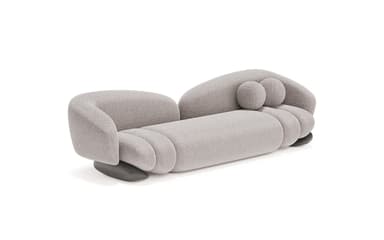 A contemporary, generously sized sofa with an organic, bulbous form. It features a low profile with rounded arms that curve inward, and a plush, textured upholstery. The seat and backrest are segmented, creating a unique visual texture. Two spherical throw pillows are integrated into the design, resting on the backrest. — 3D model
