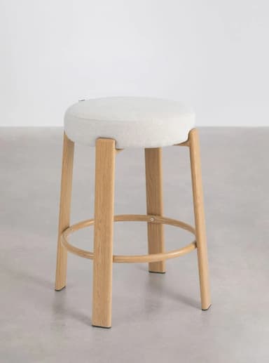 A modern stool featuring a round, light-colored upholstered seat and four splayed wooden legs, connected by a circular wooden footrest. — 3D model