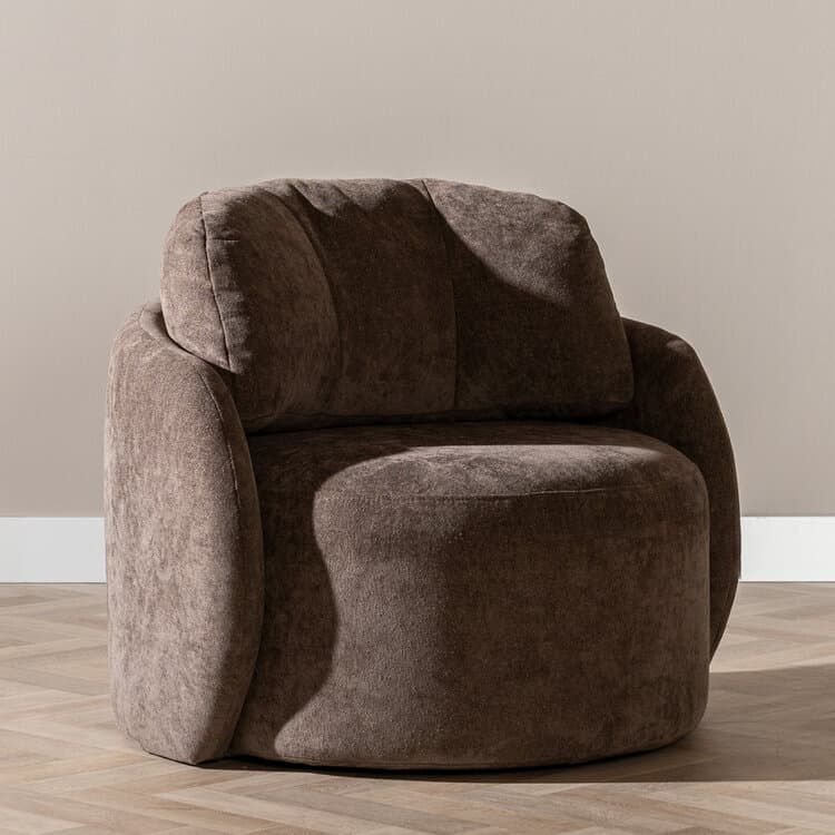 A contemporary upholstered lounge chair featuring a plush, rounded barrel silhouette in a taupe-brown textured fabric. The chair has integrated armrests and a thick, comfortable backrest, offering a cocoon-like seating experience. Its design emphasizes softness and comfort, suitable for modern living spaces. — 3D model