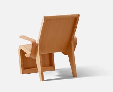 A modernist bent plywood lounge chair featuring a natural light wood finish. The design includes a low-slung, reclined backrest, a subtly curved seat, and integrated armrests, all formed from laminated wood sheets. The frame utilizes angular, broad supports, showcasing a minimalist and organic aesthetic with visible joinery. — 3D model