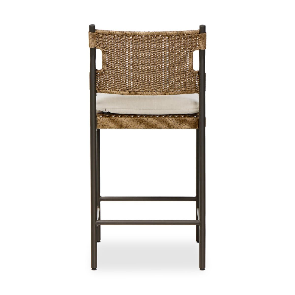 A contemporary bar stool featuring a dark-colored metal frame, a woven synthetic rattan seat and backrest, and a light-colored fabric cushion. The stool includes an integrated footrest for comfort. The backrest has cut-out handles on either side, and the overall aesthetic is clean and modern, suggesting suitability for both indoor and outdoor environments. — 3D model